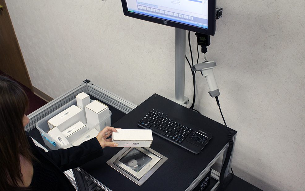 employee QC scanning cartons for quality