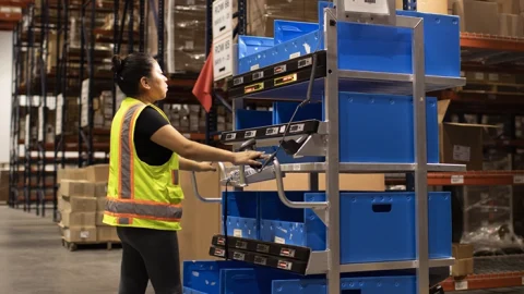 woman using ergonomic warehouse picking smart cart