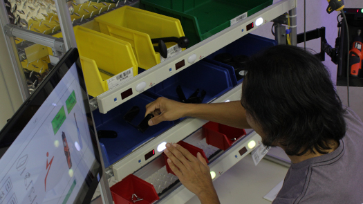 Pick-to-Light system on manufacturing workstation being used to pick parts and build products.